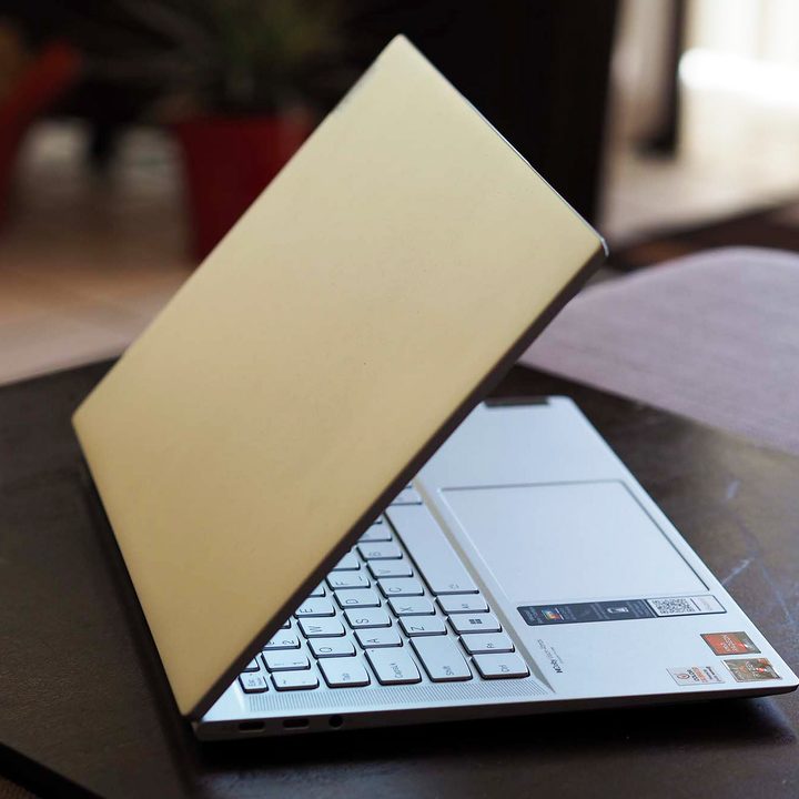 A Lenovo IdeaPad Slim 7 Carbon sits angled on a desk.