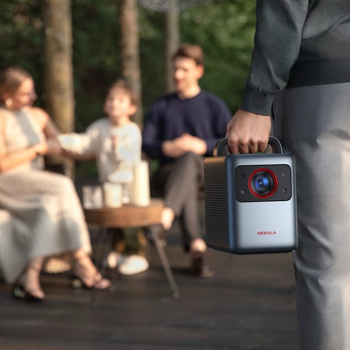 Anker Nebula Cosmos Laser 4K being carried outside.