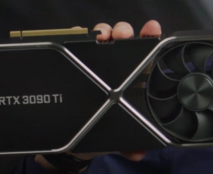 A hand holds the new RTX 3090 Ti graphics card.