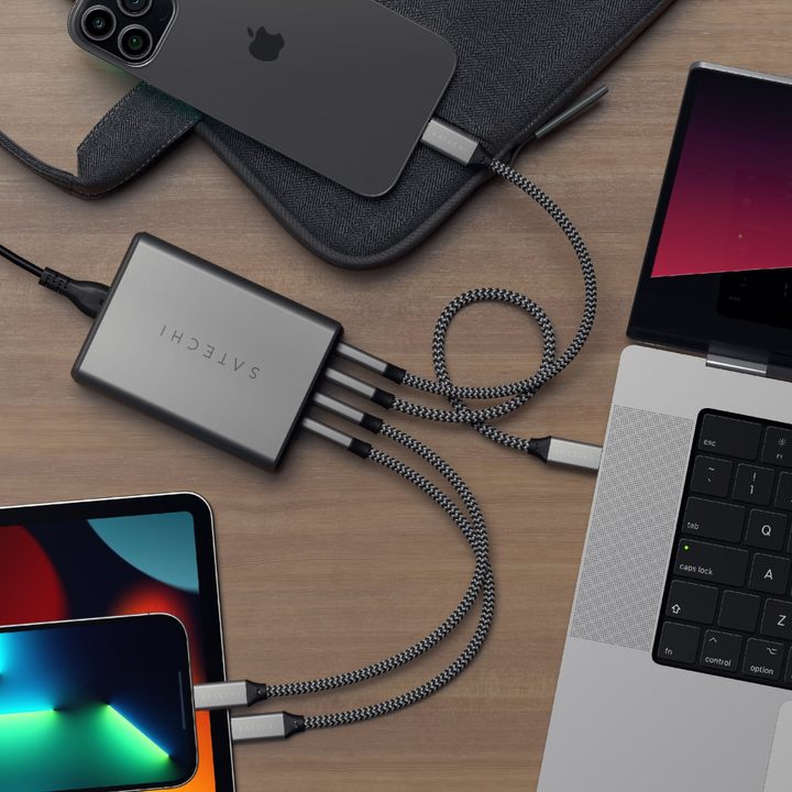 Picture of Satechi's new 4-port USB-C charger on a desk connected to a MacBook, iPhone, and iPad.