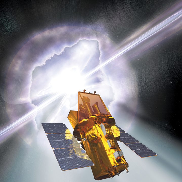 An artist's rendering of the Swift spacecraft with a gamma-ray burst going off in the background.