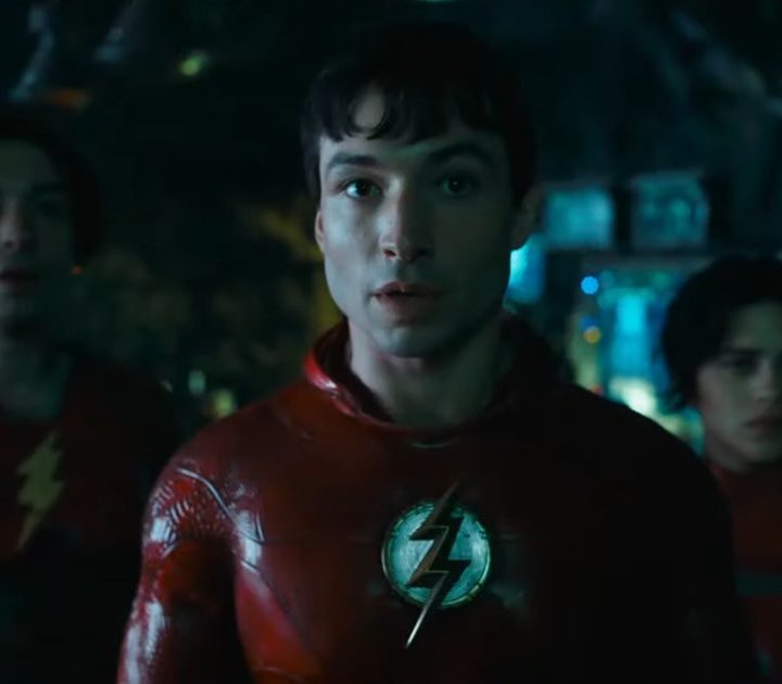 Ezra Miller as The Flash, standing looking ahead.