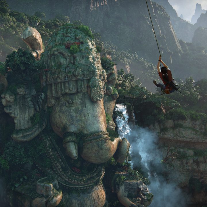 Chloe swings by a statue of Ganesha in Uncharted: The Lost Legacy.