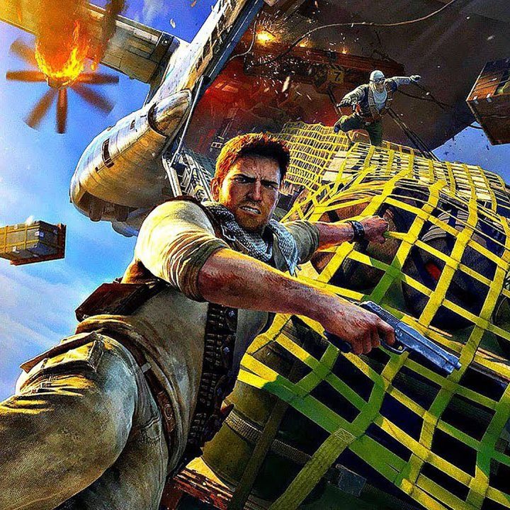 A promotional image for Uncharted 3 show Nathan Drake hanging on to cargo falling out of the back of a plane..