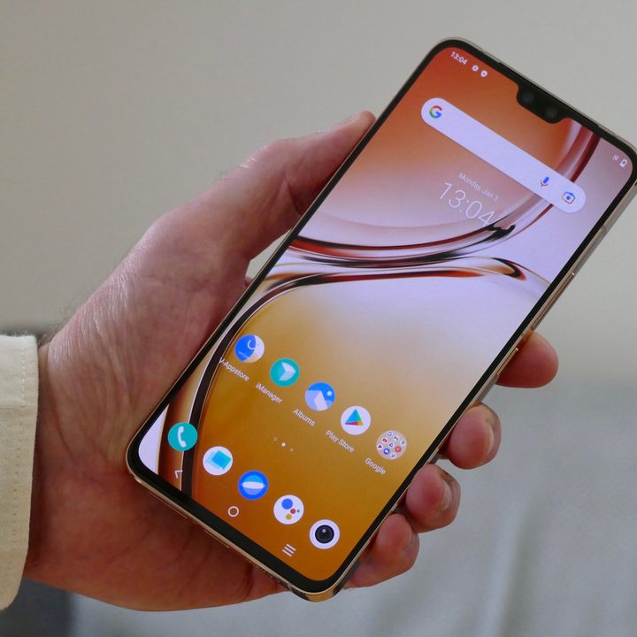 Vivo V23 held in hand.