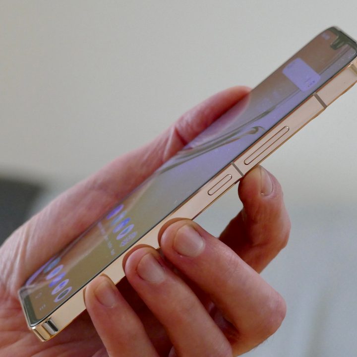 Vivo V23 held in hand.