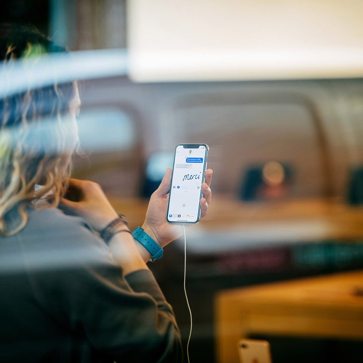Woman using the iMessage Animoji and chat message.