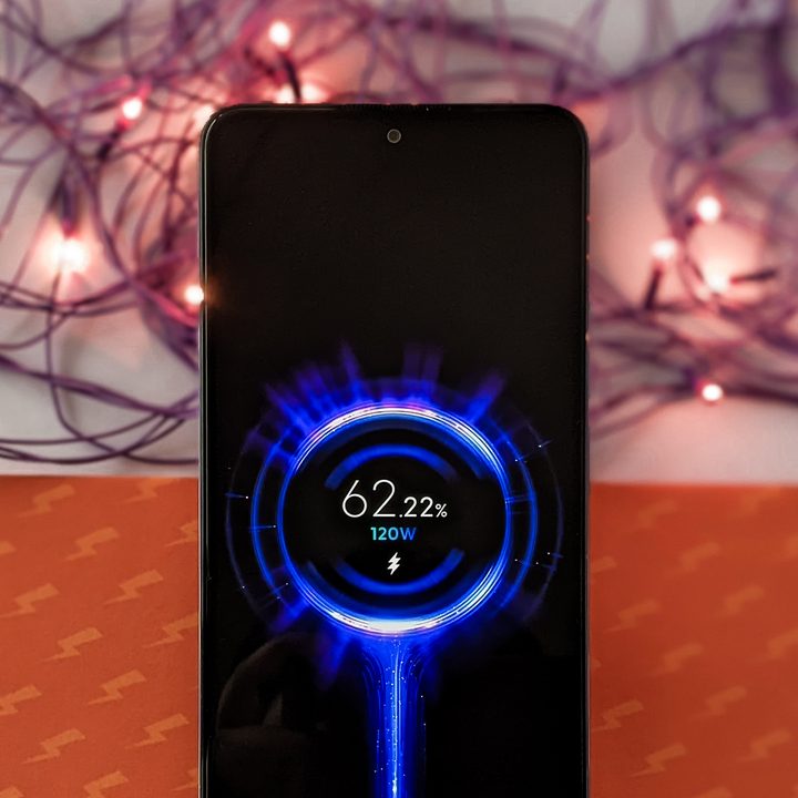 Xiaomi Mi 11i HyperCharge aka Redmi Note 11 Pro China variant with 120 watt fast charging against orange background with purple twinkle lights.
