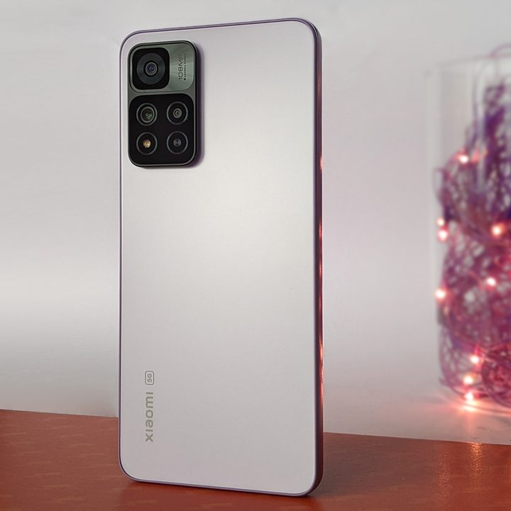 Xiaomi Mi 11i HyperCharge aka Redmi Note 11 Pro China variant in purple color with 120 watt fast charging against orange background with purple twinkle lights.