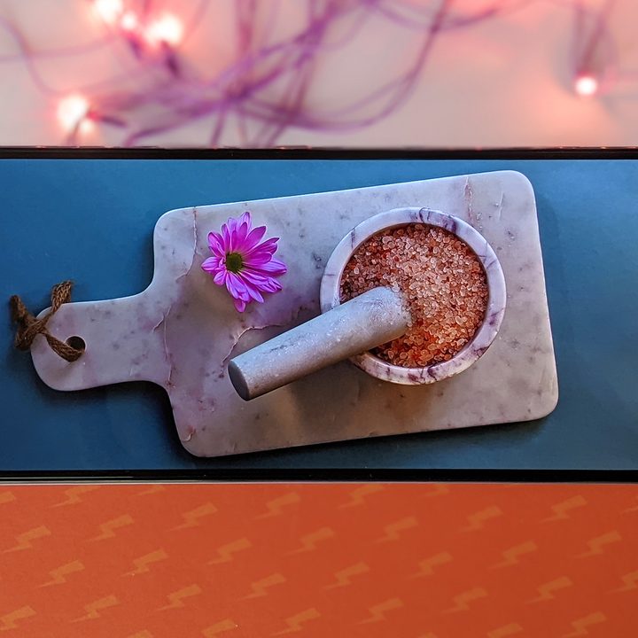 Xiaomi Mi 11i HyperCharge with 120 watt fast charging against orange background with purple twinkle lights while playing 4K HDR video on YouTube.