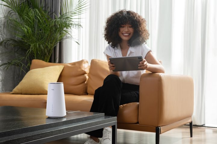 A woman is connected to the LINKHUB 5G CPE router.