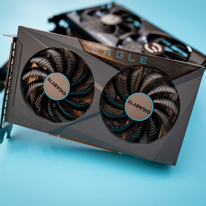 An AMD RX 6500 XT with other graphics cards stacked up in the background.