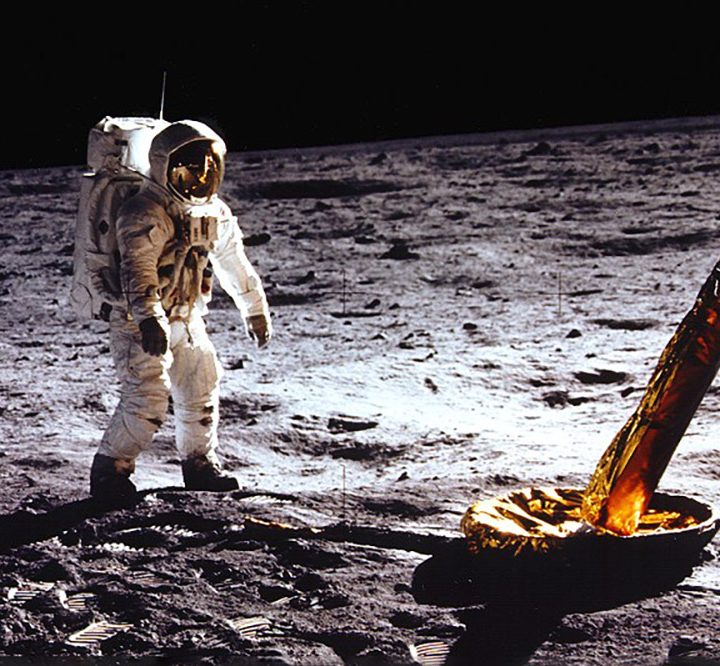 An astronaut walks on the moon during the Apollo 11 Mission.