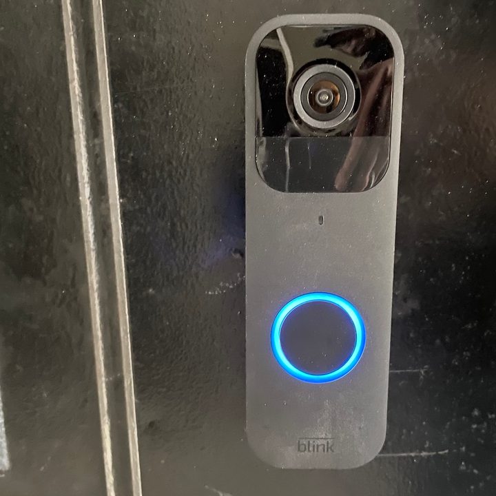 The Blink Video Doorbell mounted on the door.