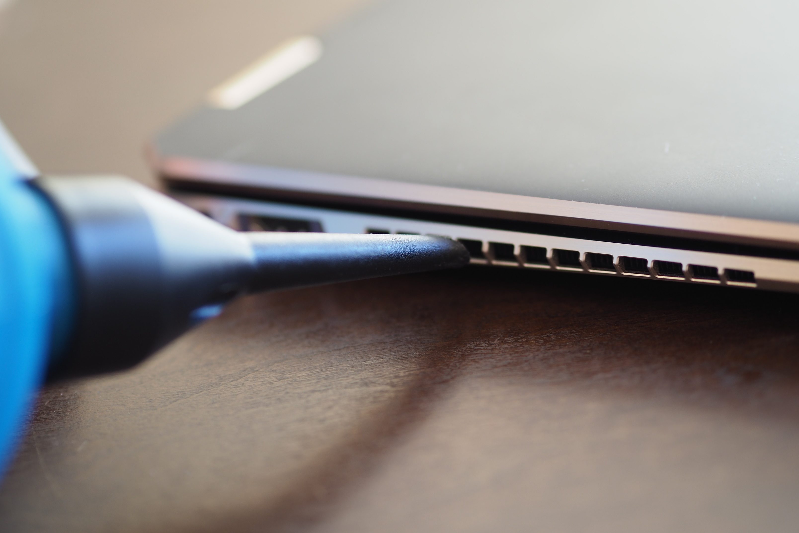 Blowing the air into a laptop exhaust vent.
