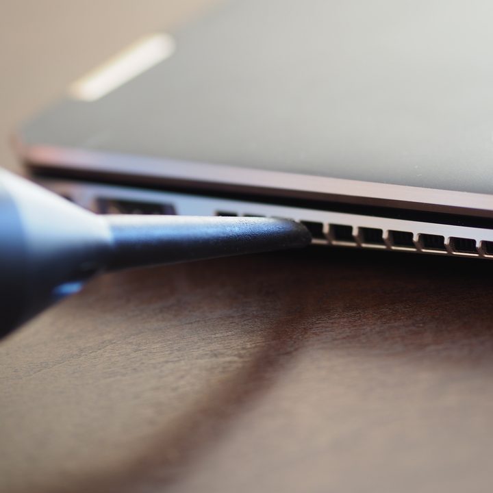 Blowing the air into a laptop exhaust vent.