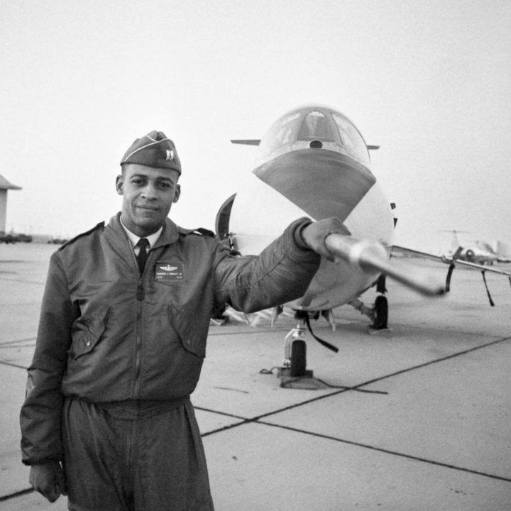 Capt. Ed Dwight stands in front of an F-104 jet fighter.