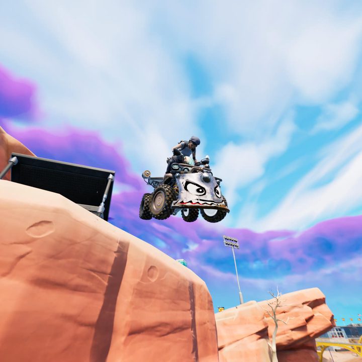 Flying through the air on a quad in Fortnite.