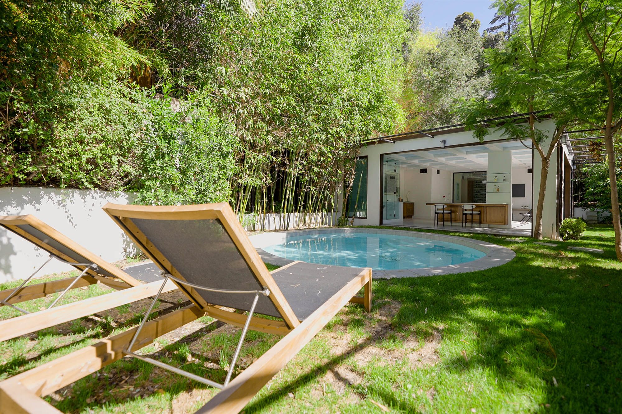 A nice round pool in the backyard.