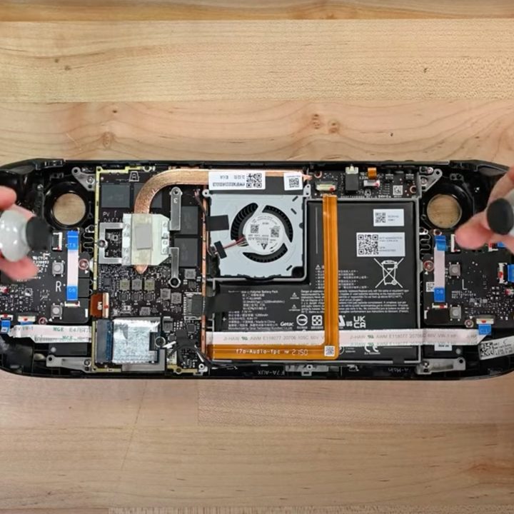 A Steam Deck with the back covered removed, showing that one can easily remove the thumb sticks.