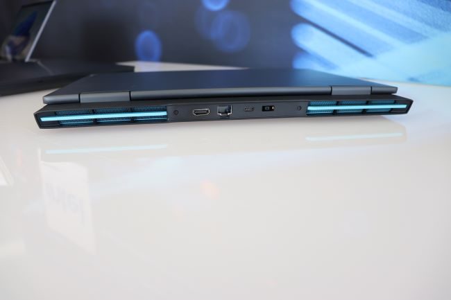The rear of the black 16-inch IdeaPad Gaming 3 showing its I/O ports and vents and blue decals.