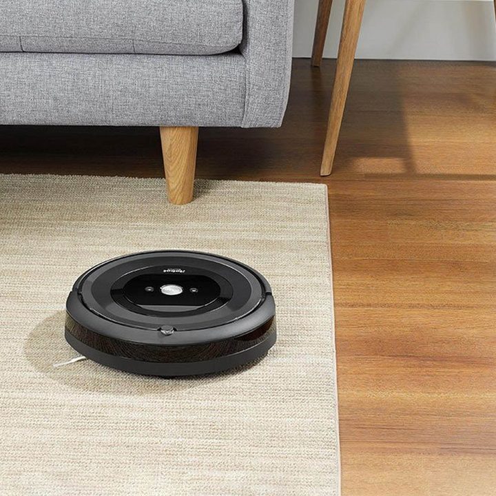 iRobot Roomba e5 press image of a vacuum on carpet.
