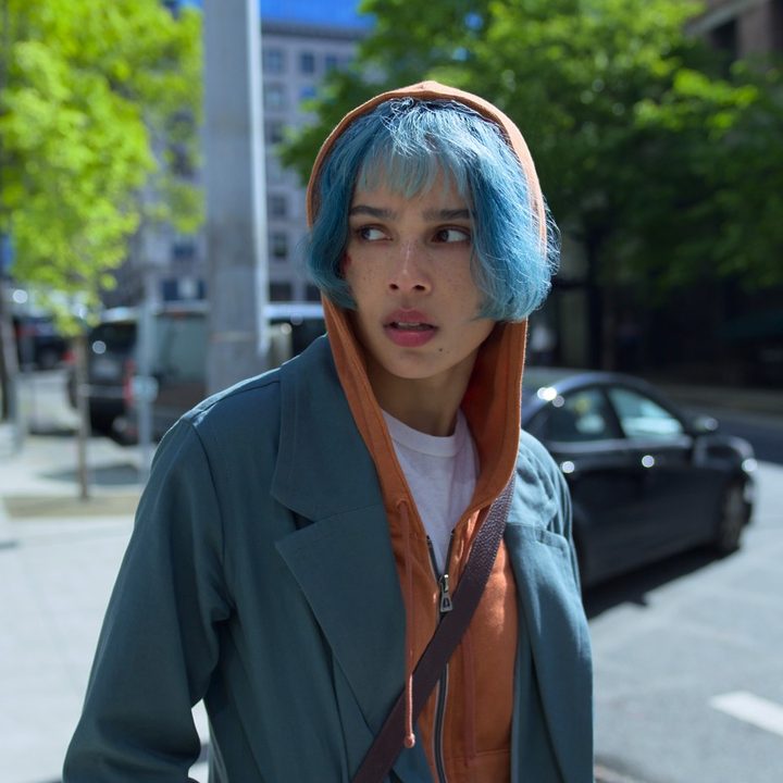 Zoe Kravitz walks down a street in Seattle in a scene from KIMI.
