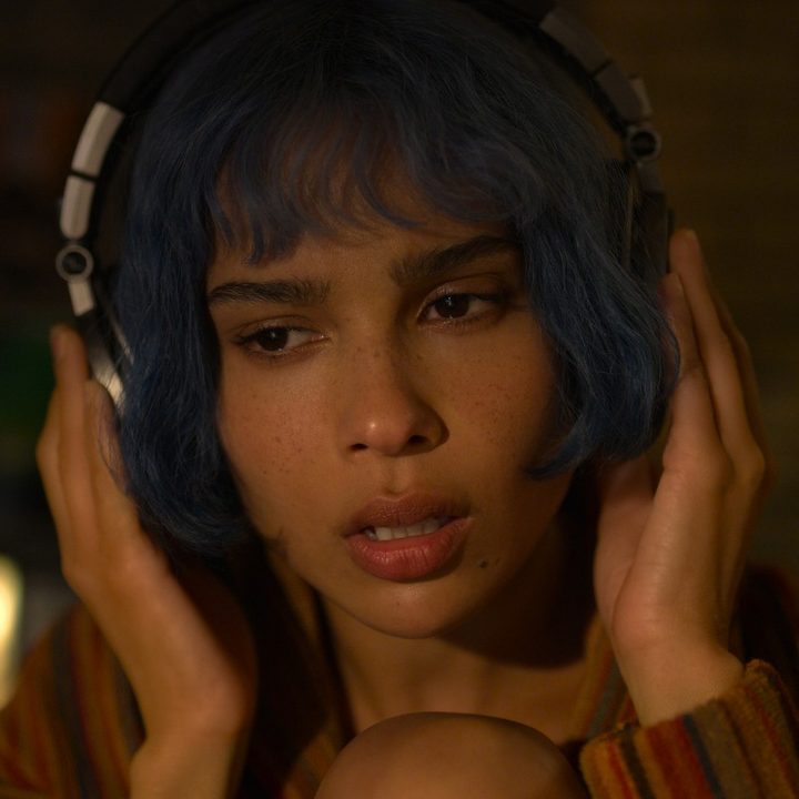 Zoe Kravitz listens to headphones in a scene from KIMI.