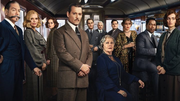 The cast of Murder on the Orient Express poses inside a train.