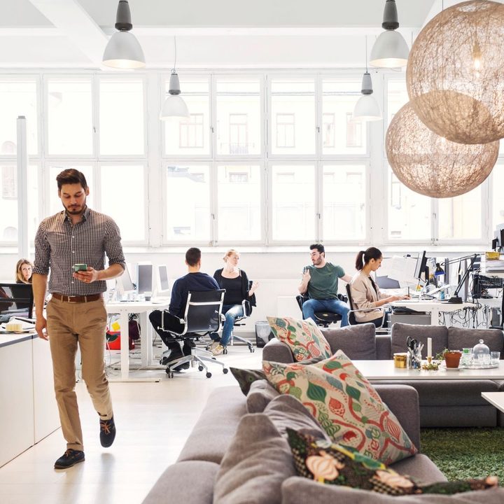 People working and collaborating in open office space.