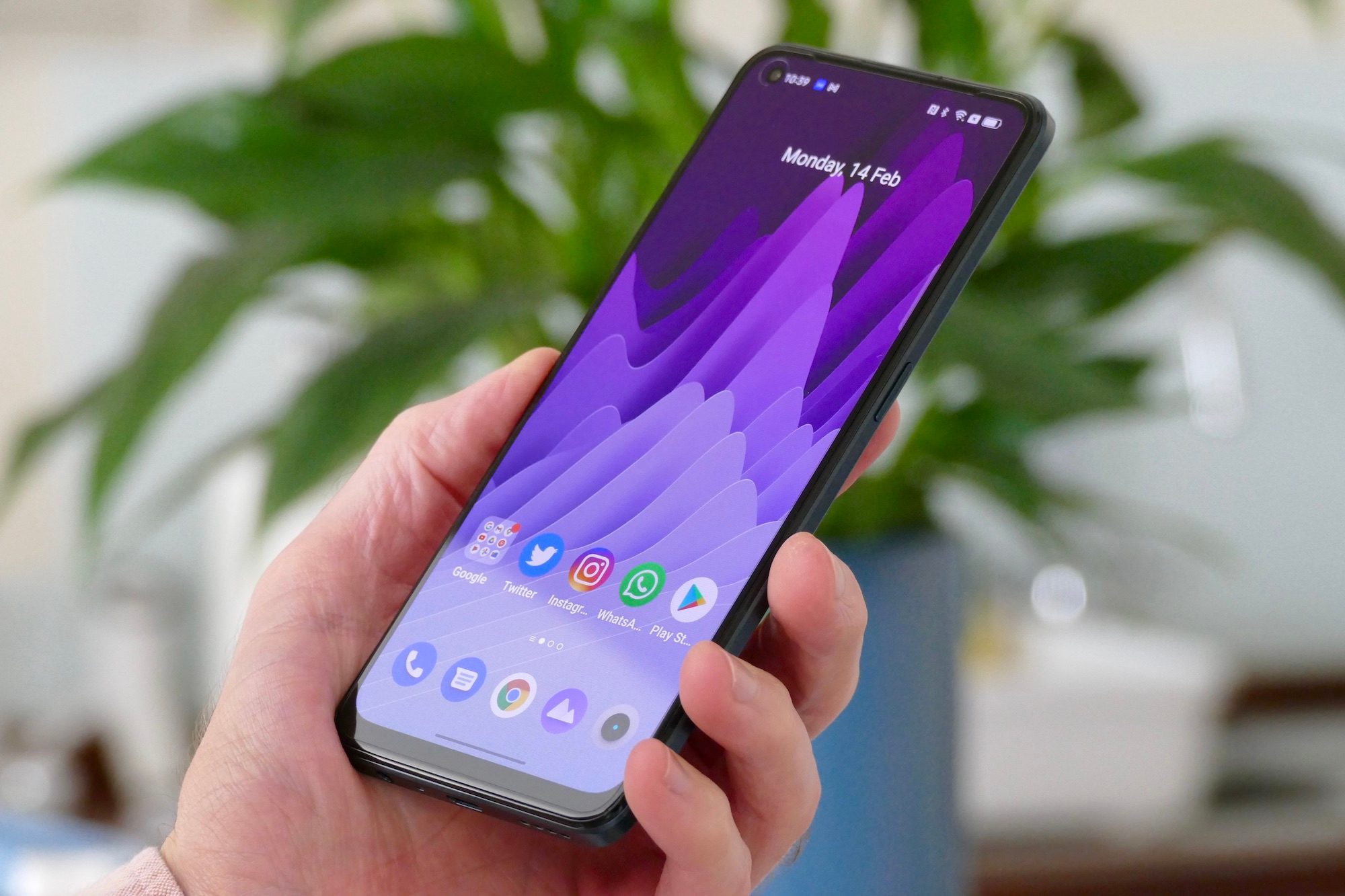 Realme 9 Pro+ held in hand showing the screen.