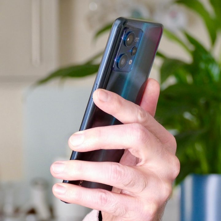 Realme 9 Pro+ held in hand.