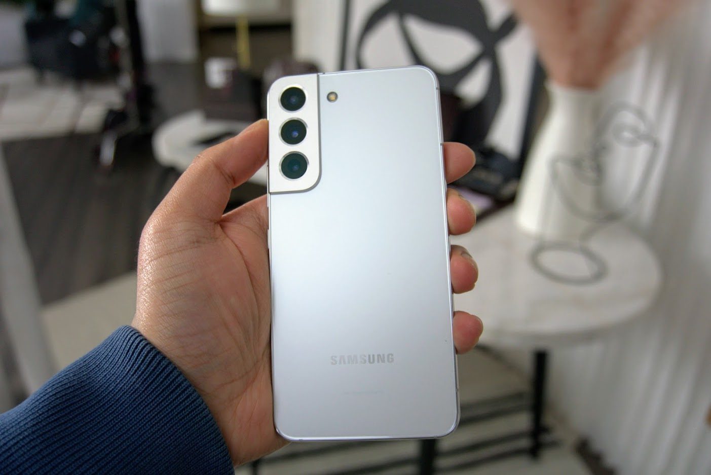 Samsung Galaxy S22 Plus in Phantom White in hand.