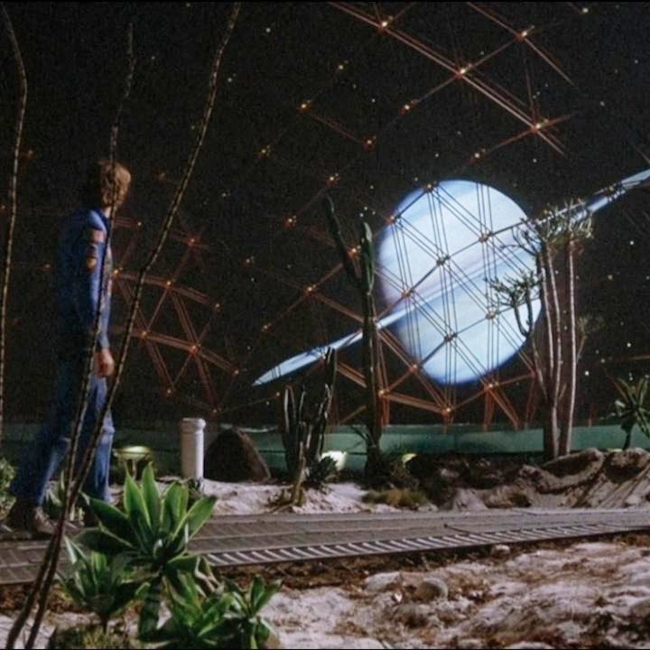 A man looks at Saturn from a space colony in Silent Running.