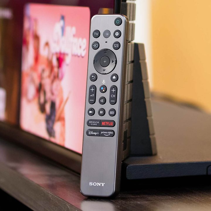 A Sony A95K remote propped up against the TV.