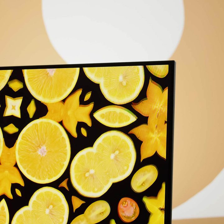 A closeup on the Sony A95K TV's screen displaying an image of citrus fruits.