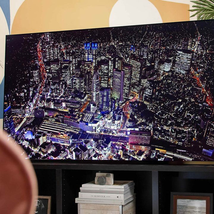 An aerial view of a city is shown on the Sony A95K, showcasing the backlight.