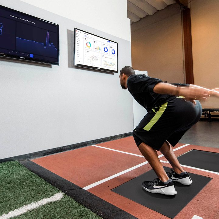 An athlete uses a Sparta Science smart scale & force plate.