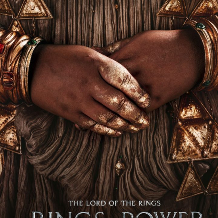 A hand covered in gold flakes in The Rings of Power.