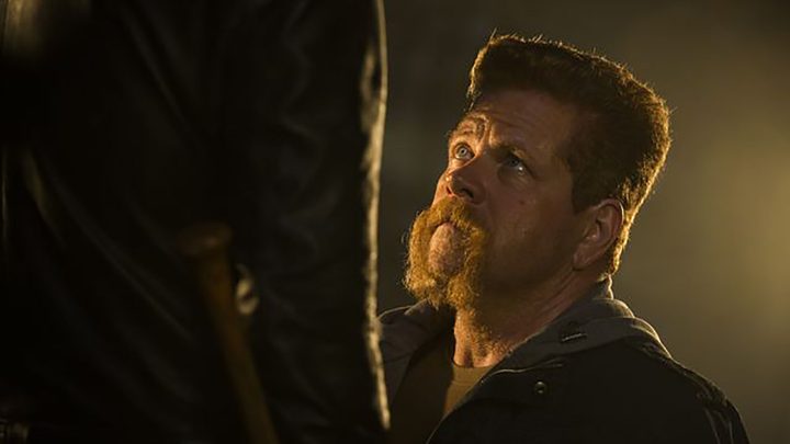 Abraham from The Walking Dead kneeling on the ground, staring up at Negan.