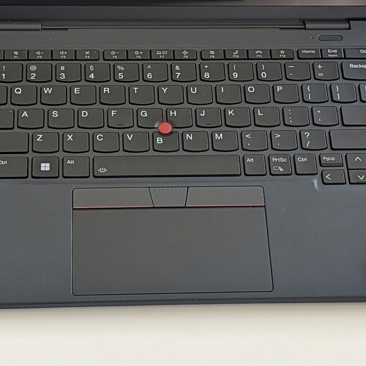 A grey keyboard with red accents on the Thinkpad x13s.