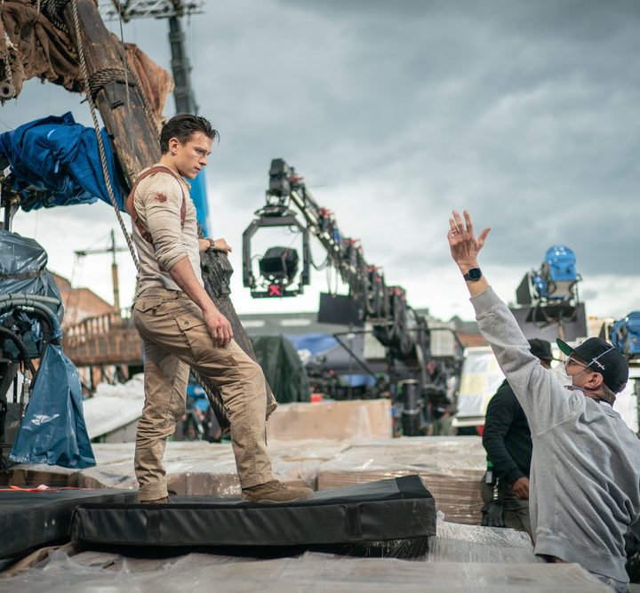 Tom Holland stands on set as Nathan Drake in Uncharted.