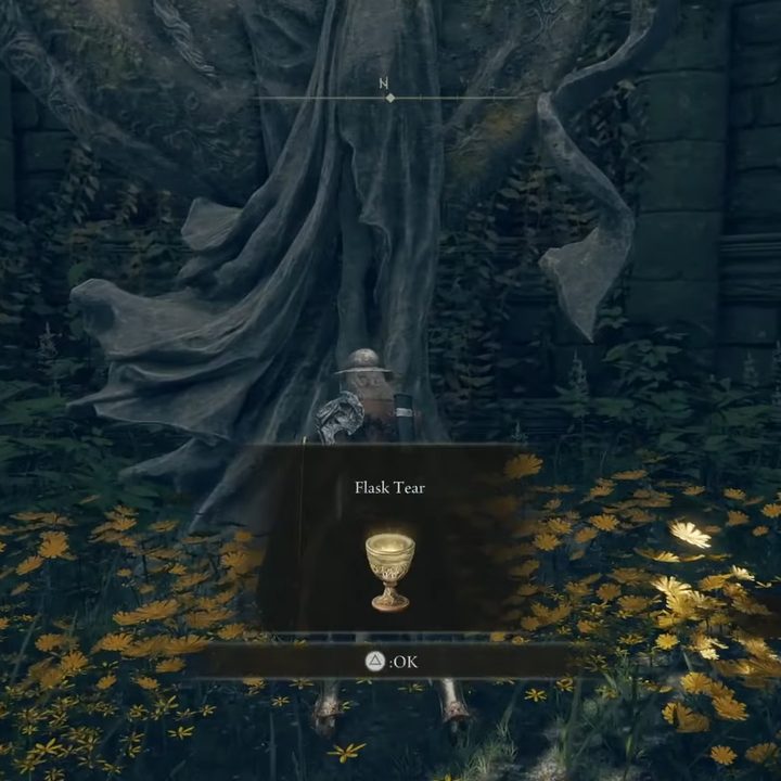 A player character picks up a sacred tear item in Elden Ring.