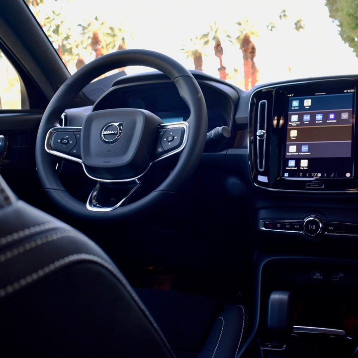 Interior view of the 2022 Volvo C40 Recharge electric car including the steering wheel and touchsreen.