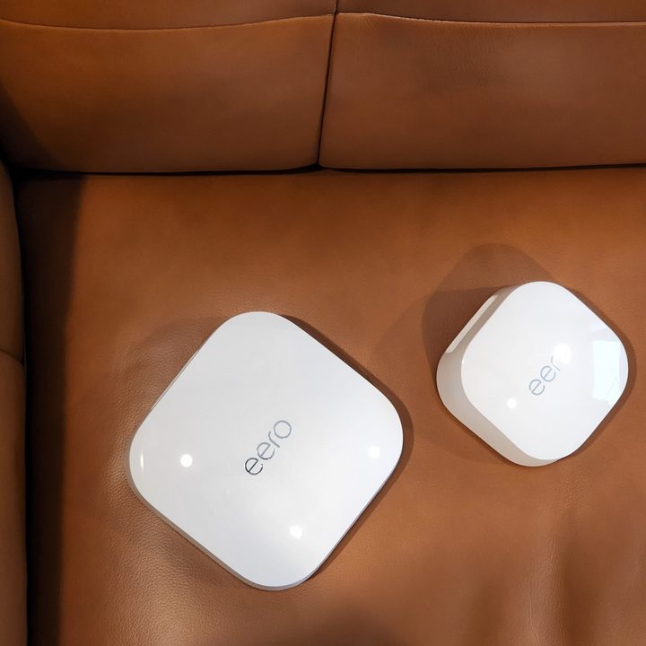 A view of the Eero Pro 6E with Wi-Fi 6E from above as they rest on a brown sofa.