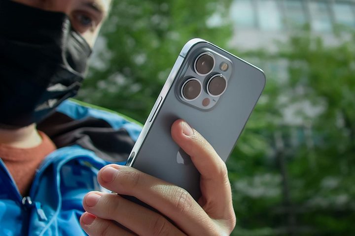 iPhone 14 Pro in hand.