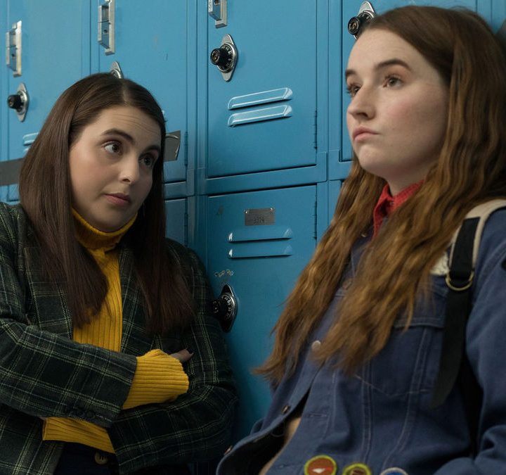Beanie Feldstein and Kaitlyn Dever lean against lockers in Booksmart.