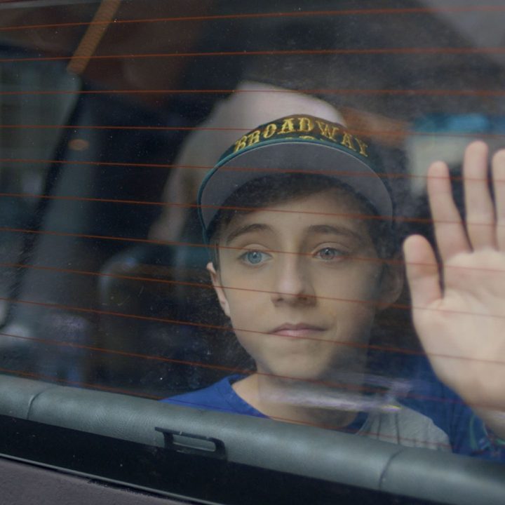 Nate holds his hands against a car window in Better Nate Than Ever.