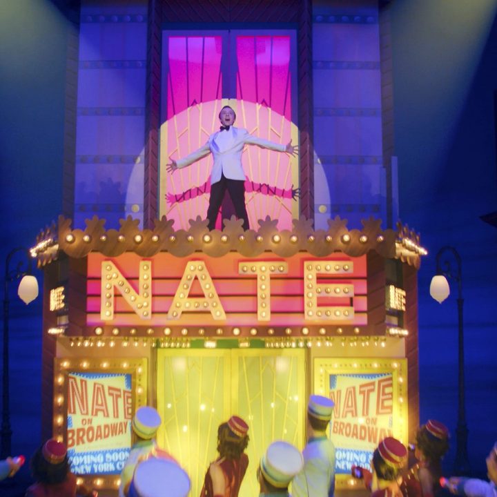 Nate stands atop a marquee in Better Nate Than Ever.