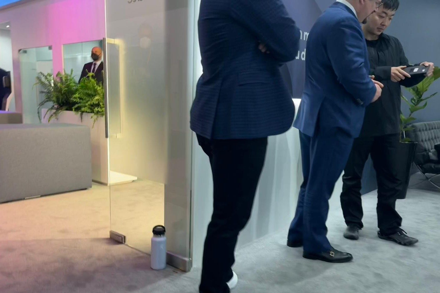 Nothing's Carl Pei, right, shows a phone to Qualcomm's Cristiano Amon.